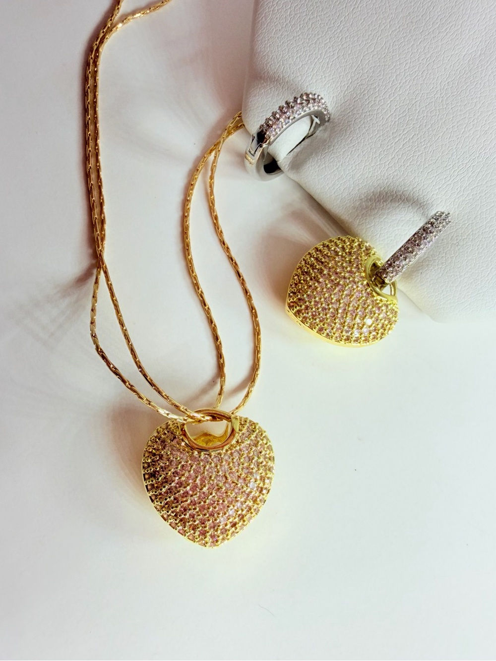 Gold and silver heart earrings adorned with diamond-like CZcrystals rhodium plat